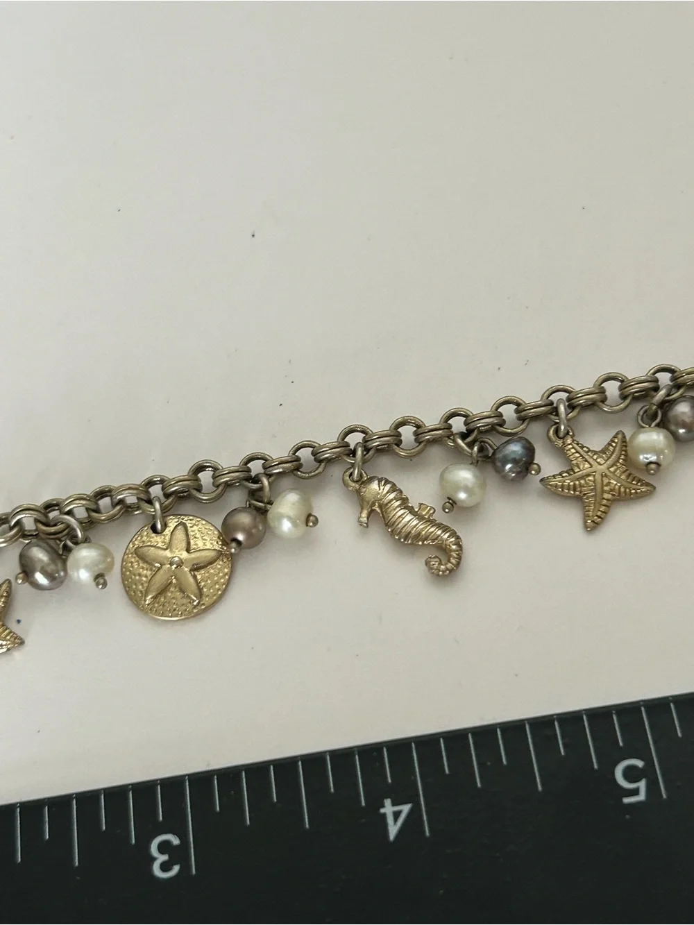 Gold-Tone Under the Sea Lia Sophia Seashell Charm Bracelet with Pearls (6) - Picture 3 of 6